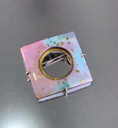 Modern opalescent kiln fired enamel with 24K gold in shades of blue, violet, golden pink and rose. Set into a sterling silver and 24K gold keum-boo back. Custom modified C clasp closure, 1.5" X 1.5". *please use contact form to request additional information or photos, thanks! Luxury Silver Enamel Brooches, Luxury Enamel Brooch As A Gift, Luxury Enamel Wedding Brooches, Luxury Cabochon Enamel Jewelry, Luxury Enamel Cabochon Jewelry, Luxury Enamel Brooch Jewelry, Luxury Silver Enamel Jewelry, Luxury Fusion Enamel Jewelry, Luxury Handmade Enamel Brooches