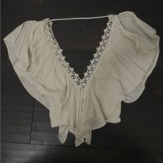 Embroidered Trim Chic Embroidered Tops For Vacation, Chic Embroidered Beach Tops, Embroidered Beige Tops For Vacation, Beige Floral Embroidered Beach Top, Embroidered White Tops For Beach Season, Beige Floral Embroidery Tops For Beach, Chic Floral Embroidery Blouse For Beach, Beige Floral Embroidered Tops For Beach, Cream Embroidered Tops For Vacation