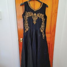 Beautiful Dark Navy Blue With Gold Embroidery Work On The Next Line. Brand New Without Tag. Elegant Floor-length Embroidered Fabric With Gold Details, Elegant Floor-length Embroidered Fabric With Gold Embroidery, Elegant Floor-length Gold Embroidered Fabric, Blue Floor-length Embroidered Dress For Wedding, Sleeveless Embroidered Dress With Resham For Wedding, Formal Festive Maxi Dress With Floral Embroidery, Elegant Blue Embroidered Floor-length Dress, Elegant Blue Floor-length Embroidered Dress, Festive Floor-length Gown With Gold Embroidery