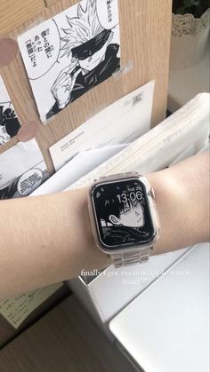 an apple watch on someone's arm in front of some papers and envelopes