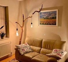 a living room filled with furniture and a tree in the middle of it's wall