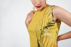 "S T R A I G H T T A L K ▲ Circa: 1960s ▲ Tag: Marie Ah You Couture, Tahiti ▲ Material: Cotton ▲ Condition: Very Good D E T A I L S ▲ Soft yellow cotton with hand printed florals ▲ Sleeveless ▲ Side pleat ▲ Unlined ▲ Back zipper entry C O N D I T I O N ▲ Very Good S I Z I N G ▲ Would probably best fit a size Small/Medium. This is just an estimate - please check measurements below. Bust: 38\" Waist: 35\" Hips: 41\" Shoulder to hem (dress length) : 37\" FOLLOW US ON INSTAGRAM: @animalheadvintage W Fitted Sleeveless Tropical Dresses, Elegant Sleeveless Dress With Tropical Print, Yellow Tropical Style Sleeveless Dress, Yellow Sleeveless Tropical Dress, Yellow Tropical Sleeveless Dress, Yellow Tropical Print Sleeveless Dress, Yellow Sleeveless Silk Dress, Sleeveless Silk Summer Dress, Trench Cape