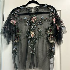 Beautiful Zara Embroidered Tulle Blouse With Detailed Sleeve In Size M Never Worn But The Tag Was Taken Off Fitted Floral Applique Top For Parties, Festive Black Embroidered Top With Floral Details, Black Embroidered Party Blouse, Festive Black Embroidered Floral Top, Festive Black Floral Embroidered Top, Festive Floral Embellished Summer Top, Black Embroidered Tops For Summer, Black Summer Tops With Intricate Embroidery, Black Tops With Intricate Embroidery For Summer