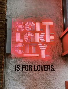 a red neon sign that says salt lake city is for lovers