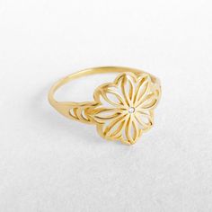 "A unique gold flower statement ring with a delicate clear or black diamond. Handcrafted craftmenship at it's best - 100% Top quality Gold, 100% handcrafted for each and every customer. Maya Mor Jewelry is dedicated to contemporary and avant-garde jewelry and to one-of-a-kind pieces that are personally designed and created by Maya. The jewels are handmade with skillful goldsmithing work and advanced technologies, comfortable to wear due to their ergonomic shapes and carefully finished with the p Heirloom Diamond Flower Ring Gift, Gold Flower-shaped Promise Ring, Gold Flower-shaped Ring For Gift, Gold Flower Shaped Ring For Gift, Gold Flower Shape Promise Ring, Gold Diamond Flower Promise Ring, Gold Diamond Flower Ring For Promise, Gold Diamond Flower-shaped Ring, Flower Shaped Yellow Gold Diamond Ring As A Gift