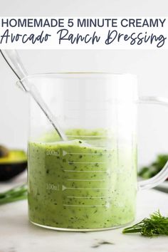 homemade 5 minute creamy avocado ranch dressing in a measuring cup with a spoon