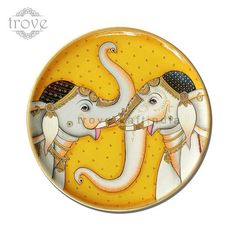 an image of two elephants that are painted on a plate with gold trimmings