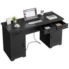 a laptop computer sitting on top of a desk next to a cup and pen holder