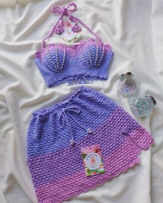 two pieces of crocheted swimwear on a bed