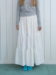 Color: WHITECountry of Origin : Republic of Korea White Flared Skirt With Ruffle Hem, White Ruffle Hem Skirt For Spring, White Ruffled Flared Maxi Skirt, Spring Cotton Skirt With Ruffles, White Flowy Skirt With Ruffle Hem, Flowy White Skirt With Ruffle Hem, White Cotton Bottoms With Ruffle Hem, White Skirted Bottoms With Ruffle Hem, Casual White Skirt With Ruffle Hem