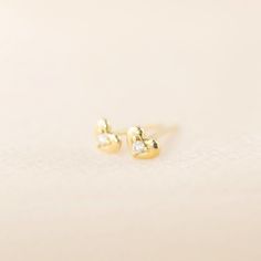 Sweet and petite 14k solid gold heart studs with a single diamond shine in a polish finish. A lightweight yet sturdy piece that is perfect for everyday wear. Simple diamond heart studs to go with any outfit. This earring will make a sweet gift symbolizing feelings of love and appreciation. Purchase this for birthdays, anniversaries or holidays! * Sold as one pair or single stud * Heart width x height: ≈5mm x ≈4mm * Diamond weight: ≈0.03ct (0.015ct for single stud) * Earring post: 10mm long * Clo Gold Diamond Heart Earrings In Dainty Style, Tiny Dainty Yellow Gold Heart Earrings, Dainty Diamond Heart Earrings In Gold, Dainty Gold Diamond Heart Earrings, Dainty Tiny Yellow Gold Heart Earrings, Yellow Gold Heart Earrings For Anniversary, Dainty 14k White Gold Heart Earrings, Elegant Small Yellow Gold Heart Earrings, Tiny Diamond Earrings