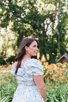 Warm days aren’t complete until you stroll in the Verona Dress. This dress features a beautiful blend of pastel blues and yellows to elevate your style and spirits. Statement sleeves and a full-length skirt add irresistible charm to your look, while the elastic waistline provides generous stretch and all-day comfort. This dress is perfect for soon-to-be mothers with bump-friendly ensembles. STYLE INFO & CARE The smocked bodice for a flexible, comfortable fit Skirt lined 100% polyester Maternity Fit Skirt, Statement Sleeves, Full Length Skirts, Blue Midi Dress, Fitted Skirt, Pastel Blue, Verona, Bump, Floral Dress