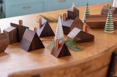 small wooden christmas trees sitting on top of a table