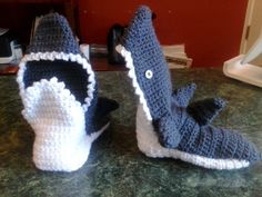 two crocheted slippers sitting on top of a counter