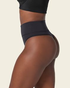 This shaper thong panty is the perfect combo between compression and coverage. Moderate compression in the mid-to-lower tummy shapes your silhouette comfortably. Made of our super soft seamless SkinFuse® fabric for a second skin feel. Its double-layered waistband and flexible boning keep it in place and accentuate your curves. Compressive Shapewear Bottoms With Built-in Bra, Supportive High Stretch Seamless Shapewear, Sleek Seamless Shapewear, Solid Compression Brief Shapewear, Seamless Compression Shapewear, Compression Brief Shapewear In Solid Color, Solid Color Compression Brief Shapewear, Solid Color Compression Shapewear Brief, Sleek Stretch Shapewear With Seamless Construction