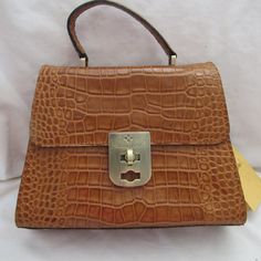 Description: Brand: Patricia Nash Chauny Condition: New With Tags Color: Cognac/Brown Material: Leather Style: Crossbody Hardware: Polish Dust Cover: Yes Closure: Zipper Bag Height: 8.0" Inches Bag Width: 10" Inches Bag Depth: 4.0" Inches Exterior Details: 1 Pocket Interior Details: Zipper Pockets And 2 Elastic Pockets, 1 Side Pockets Inside The Purse Cognac Rectangular Bag With Turn-lock Closure, Brown Rectangular Satchel With Turn-lock Closure, Brown Rectangular Bag With Turn-lock Closure, Brown Rectangular Bags With Turn-lock Closure, Brown Satchel With Turn-lock Closure For Daily Use, Brown Shoulder Bag With Turn-lock Closure And Double Handle, Brown Double Handle Shoulder Bag With Turn-lock Closure, Cognac Bags With Turn-lock Closure, Cognac Leather Bag With Turn-lock Closure