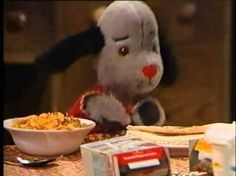 a stuffed animal sitting at a table with food