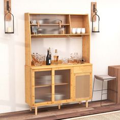 a wooden cabinet sitting on top of a hard wood floor next to a white wall