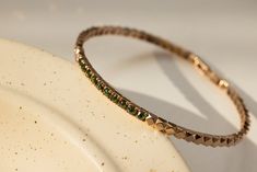 Handcrafted in a unique cut design, the Tina Diamond Bangle emanates maximum shine all around the band, with colored diamonds to add character to the piece. Available in blue or green diamonds. Dimensions: 17 cm (approx. 6.69 in) Materials used (pictured): 14K solid rose gold, 9.1 g10 x rough blue / green diamonds ﻿Note﻿: Only the Green Diamonds / Rose Gold option is Ready to Ship. Other options can be ordered but standard delivery times apply. Green Diamonds, Green Diamond, Diamond Bangle, Green Rose, Rough Diamond, Cut Design, Colored Diamonds, Blue Yellow, Gold Color