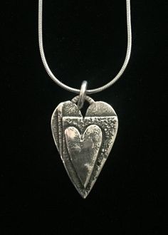 "This pendant consists of three layers of silver with a 5/8\" heart on top. The texture is a result of heating and reheating the metal almost to a melting point." Melting Point, Hermosa Beach, Heart On, Heart Necklace, Pendant Necklaces, Dog Tag Necklace, Jewelry Necklace Pendant, Jewelry Necklaces, Necklaces