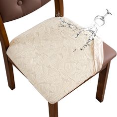 a close up of a chair with a pillow on it's back and an object in the seat