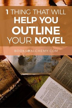 an open book sitting on top of a wooden table next to other books and papers