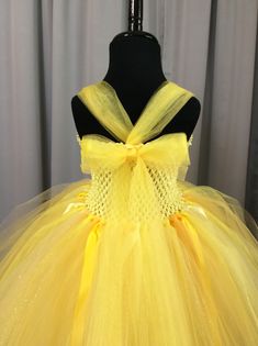 Fuzzy Duckling Design dresses ~ handcrafted for the little princess in your life. Our beautiful dresses feature a stretchy, crocheted bodice that is fully lined for both comfort and modesty. The full skirts sparkle and shine with three layers of high quality tulle in matte, shimmer, and glitter finishes. Satin ribbons, flowers, and jewels are added to make each dress something special. She'll feel like a fairy princess when wearing her matching accessories. This dress includes a matching sparkly Fairytale Tulle Fairy Dress For Pageant, Fairytale Tulle Fairy Dress For Pageants, Princess Style Tutu Dress For Costume, Yellow Fitted Princess Tutu Dress, Fairycore Tulle Tutu Dress For Parties, Yellow Tulle Princess Dress, Yellow Princess Dress For Pageant, Princess Style Fairy Dress For Pageant, Princess Style Fairy Dress For Pageants