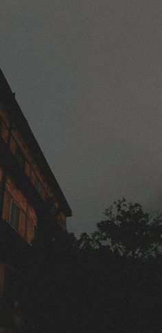 a clock on the side of a building at night