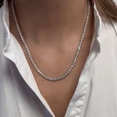 This Diamond Tennis Necklace is a breathtaking piece of jewelry that features a row of dazzling diamonds set in a classic 3-prongs setting. The necklace is crafted from 14K Gold and has a total diamond weight of 10.30 carats. The 3-prongs setting used in this necklace is designed to hold the diamonds securely in place while also allowing maximum light to enter and reflect off the stones. This creates a brilliant and radiant effect that is sure to catch the eye of anyone who sees it. The 14K Gold Tennis Necklace Styling, Tennis Diamond Necklace, Tennis Necklace Diamond, Diamond Tennis Necklace, 14k Yellow Gold Necklace, Accesories Jewelry, Gold Diamond Necklace, White Gold Necklaces, Tennis Necklace