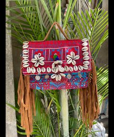 About bag  Indo-gypsy fusion, everyday use hand bag made from Banjara fabrics sourced from Vintage tribal costumes of regions of Rajastan and Gujarat. These are embellished with light catching coins, and intricate bead work tassels. Size - length 15 inches/ width 21 inches Company details:  Company name: Houseoftextile  Contact number: +919784447473  Email id: houseoftextile77@gmail.com  Shipping & custom : Delivery through one of the finest service providers : Skyway, Fedex, UPS  And DHL. Any l Handmade Tote Shoulder Bag For Festivals, Festival Handmade Rectangular Shoulder Bag, Traditional Rectangular Festival Bags, Red Beach Bag With Tassels, Rectangular Festival Bag For Daily Use, Traditional Rectangular Potli Bag For Travel, Festival Rectangular Bags With Multicolor Embroidery, Bohemian Rectangular Embroidered Bag, Rectangular Handwork Festival Bag