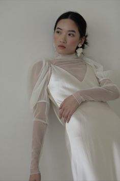 Model wearing puff sleeve net long sleeve bodysuit and silk wedding gown with statement ivory geometrical stone earrings. Romantic Updos, Swept Back Hair, Geometric Stone, Contemporary Bridal, Best Bride, Romantic Updo, Bridal Studio, Infinity Dress, Bride Accessories