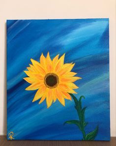 a painting of a yellow sunflower on a blue background