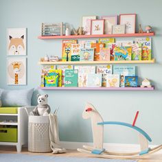 a child's room with bookshelves and toys