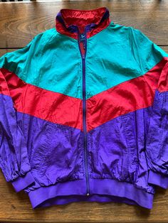 Vintage 90s Womens Full Zip Windbreaker Jacket Size Womens XL See pics for measurements Bright colors of Teal Purple & Red 100 % Nylon Quality details - pockets, ribbed sleeve cuffs, ribbed waistband. Use as a rain coat, golf jacket, or just a vintage fashion statement. Fine condition Fast shipping. We ship same or next day with USPS We are a small family business and we appreciate your purchase, Godspeed ! 1990 Clothes, Colorful Windbreaker, Teen Jackets, Bright Jacket, 1980s Fashion Trends, God Speed, Red Windbreaker, 90s Inspired Outfits, 80s Jacket