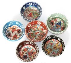 six colorful bowls with designs on them