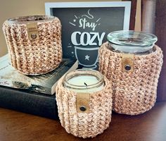 three jars are sitting on top of a book