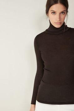 Long-sleeve high-neck tubular top made from a wool-silk blend. Elegant Stretch Mock Neck Top For Fall, Elegant Long Sleeve Mock Neck Top For Fall, Fitted Brown Tops With Seamless Collar, Elegant Fitted High Neck Sweater, Fall Merino Wool Tops With Seamless Collar, Elegant Stretch Mock Neck Top For Winter, Elegant Fitted Mock Neck Top, Elegant Mock Neck Top For Winter Layering, Elegant Fitted Sweater With Funnel Neck