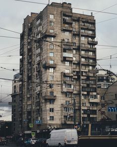 a very tall building with lots of windows and balconies on the top floor