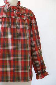 "Vintage 1970s Fall plaid blouse High neck ruffle neck + puff ruffle sleeves Great vintage condition M e a s u r e m e n t s: Size: fits like a M L BUST: 23\" Waist: 24\" Total length: 27 1/2\" Sleeves: 23\" Label: Lucky winner +All Measurements are taking while garment is lying flat+ + Jewelry, belts, and any other accessories are NOT included unless specifically stated in description+ i n s t a g r a m: cali_vintage_usa" Plaid Long Sleeve Blouse With Ruffles, Plaid Puff Sleeve Top For Fall, Gingham Puff Sleeve Top For Fall, Fall Plaid Top With Ruffles, Fall Plaid Ruffled Tops, Retro Puff Sleeve Tops For Fall, Retro Plaid Blouse For Fall, Retro Ruffled Blouse For Fall, Vintage Plaid Long Sleeve Tops