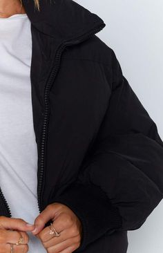 The Remi Puffer Jacket Black is the sleekest puffer jacket on the market! Its crop length and high collar make this winter basic a fashion statement. Wear it with activewear or your casual weekend outfit.


Black puffer jacket

Long sleeve

Zip-up front

Side pockets that zip up

High neck

Elastic cuffs

Black lining

Elastic drawstring around the waist Long Sleeve Puffer Jacket With Zipper For Streetwear, Sporty Puffer Jacket For Fall Streetwear, Streetwear Long Sleeve Puffer Jacket With Zipper Closure, Streetwear Long Sleeve Puffer Jacket With Zipper, Sporty Puffer Jacket For Streetwear In Fall, Trendy Hooded Puffer Jacket, Trendy Solid Nylon Outerwear, Winter Streetwear Puffer Jacket With Ribbed Cuffs, Trendy Nylon Puffer Jacket For Streetwear