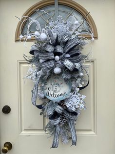 a welcome wreath hanging on the front door