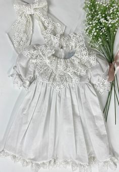 Petite Maison Kids. Made in Turkey. Charming white linen and embroidered lace dress with a large tie bow in the back. Composition: 70% Cotton, 30% Linen. Machine wash. Iron for the best look. Matching Mom version, romper style, and hair accessories available! Summer Lace Dress With Ruffles For Wedding, Elegant Baptism Dress For Spring, White Ruffled Lace Party Dress, White Ruffled Lace Dress For Party, White Lace Dress With Ruffles For Party, Lace Dress With Lace Work For Garden Party, Spring Embroidered Dress With Ruffles For Garden Party, Spring Wedding Dresses With Lace Trim, Elegant Spring Baptism Dress