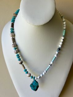 Kingman Turquoise pendant necklace with White & Turquoise Howlite, Mexican crazy lace Agate and Swarovski crystals and White gold beads with a sterling plated clasp finish this custom necklace  necklace is 21" I can add an extender if you need one. All my necklaces are different and would be considered one of a kind. View my collection of Kingman Arizona Turquoise here: https://www.etsy.com/shop/MoonwaterJewelryShop?section_id=28192591  I've been selling on eBay since 2003 Came to Etsy to sell jewelry.  Returns and exchange details ► RETURNS / EXCHANGES All items are handcrafted and custom pieces therefore we don't usually accept returns or exchanges on jewelry unless the fault was ours. Screens do not always reflect the same colors as well as seeing them in person. However, I understand t Luxury Spiritual Turquoise Necklace With Polished Beads, Luxury Chrysocolla Beaded Necklaces As A Gift, Kingman Arizona, Sell Jewelry, Turquoise Pendant Necklace, Arizona Turquoise, Turquoise Howlite, White Turquoise, Necklace Necklace