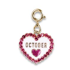 a heart shaped charm with the word october written on it and pink crystals in the shape of a heart