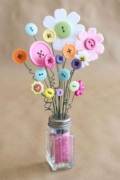 a mason jar filled with buttons and flowers