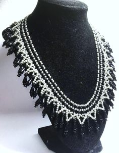 A handmade glass beaded necklace that is perfect for any occasion: parties, holidays, birthdays, anniversaries. All products are hand-crafted by my mother. Dimensions: - Actual Length: 24.0 cm - Collar Length: 16.0 cm - Width: 20.0 cm - Height: 2.0 cm Lightweight, high quality with a beaded hook as a clasp. Will respond to concerns and suggestions promptly. Acrylic Crystals: 8 mm. Shipping costs: Free Domestic Shipping. All orders are sent by air-mail with tracking number. Time of delivery: Estimated 1-3 days for domestic shipping; international make take 7-14 days. Feel free to check out our other similiar products! Link: https://www.etsy.com/shop/NurKnitsNKrafts Handmade Pearl Jewelry For Celebrations, Teardrop Black Bead Jewelry Gift, Teardrop Black Beads Jewelry As Gift, Teardrop Black Beads Jewelry Gift, Teardrop Black Beaded Jewelry For Gift, Unique White Jewelry With Black Beads, Handmade Pearl Necklaces For Celebrations, White Teardrop Beaded Necklace, Handmade Czech Glass Jewelry For Celebration