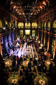 an overhead view of a banquet hall with people sitting at tables and candles on the floor