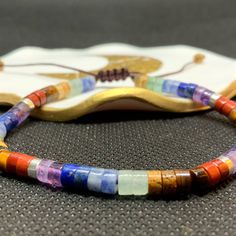 Minimalist BOHEMIAN multi coloured tiled adjustable bracelet. Chakra coloured agate stones with silver spacer beads. Finished with macramé cord making a fastening that fits from 6.7 ins to 7.5 ins wrist. Presented in a free gift box 🎁🎀 Multicolor Natural Stones Friendship Bracelets, Healing Multicolor Hand-strung Friendship Bracelets, Adjustable Multicolor Agate Beaded Bracelets, Adjustable Multicolor Bracelets For Meditation, Holistic Multicolor Beaded Bracelets With Natural Stones, Multicolor Adjustable Beaded Bracelets As Gift, Multicolor Beaded Bracelet With Adjustable Cord As Gift, Adjustable Multicolor Friendship Bracelets For Healing, Adjustable Agate Beaded Bracelets In Holistic Style