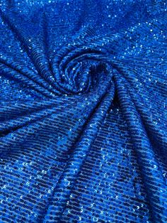 blue fabric with small white dots on the top and bottom, as if it were sequins