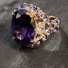 Large Purple Statement Ring, Amethyst CZ Gold Ring, AAA Grade CZ, Womens Ring Chunky ==  ABOUT THIS RING == * Condition: NEW * Metal: Steel * Finish: Gold plating * Stamp: no stamp * CZ Quality: AAA * CZ Color: Purple * Front of ring Amethyst CZ size: 17x12mm * Back of ring band width: 2.5mm * Band features: Heart cut-out tall setting For size reference, a quarter is 25mm and a nickel is 21mm Beautiful statement ring. Large faux Amethyst single CZ. AAA High quality.  Amethyst is the birthstone f February Birthday, Womens Ring, Vintage Style Rings, New Metal, Purple Band, Cz Ring, Ring Band, Heart Jewelry, Purple Amethyst